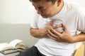 Asian middle-aged man touching his chest,suffocation and chest pain and tightness,sick male patient with heart or asthma attack, Royalty Free Stock Photo