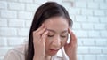 Asian middle-aged women are hold the head with hand to headaches from hopeless fatigue