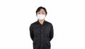 Asian middle man in a black shirt, wears a white n95 mask, stands in front of a white clear background Royalty Free Stock Photo