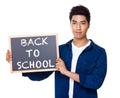 Asian mixed Indian man with blackboard showing back to school ph Royalty Free Stock Photo