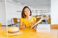 Mixed race woman reading book in library, education and lifestyle concept Royalty Free Stock Photo