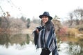 Asian model by the lake staying warm Royalty Free Stock Photo