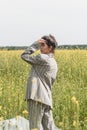 An Asian model poses in a field of yellow flowers for a clothing brand, polyethylene is the main props for a photo shoot Royalty Free Stock Photo