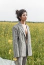 An Asian model poses in a field of yellow flowers for a clothing brand, polyethylene is the main props for a photo shoot Royalty Free Stock Photo