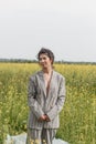 An Asian model poses in a field of yellow flowers for a clothing brand, polyethylene is the main props for a photo shoot