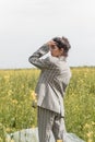 An Asian model poses in a field of yellow flowers for a clothing brand, polyethylene is the main props for a photo shoot Royalty Free Stock Photo