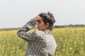 An Asian model poses in a field of yellow flowers for a clothing brand, polyethylene is the main props for a photo shoot Royalty Free Stock Photo