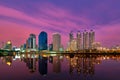 Asian modern highrises reflect in lake waters at sunset. Bangkok, Thailand. Beautiful landscape, residential area. Royalty Free Stock Photo