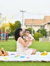 Asian mom and baby playing together in garden Royalty Free Stock Photo