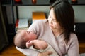 Asian mom holding her crying little baby at home Royalty Free Stock Photo