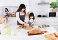 Asian mom and little daughter wearing apron Cooking Together in the Kitchen Royalty Free Stock Photo