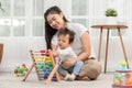 Asian mom teaching baby boy learning and playing toys for development skill at home or nursery room. Happiness mother and baby Royalty Free Stock Photo