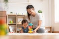 Asian mom teaching baby boy learning and playing toys for development skill at home or nursery room. Happiness mother and baby Royalty Free Stock Photo