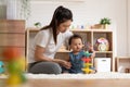 Asian mom teaching baby boy learning and playing toys for development skill at home or nursery room. Happiness mother and baby Royalty Free Stock Photo