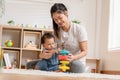 Asian mom teaching baby boy learning and playing toys for development skill at home or nursery room. Happiness mother and baby Royalty Free Stock Photo