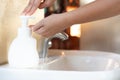 Asian Mom women wash her kid hand with soap alcohol gel for sanitizer in kitchen sink concept for prevent Hygiene health care. Royalty Free Stock Photo