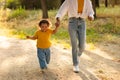 Asian Mommy Walking With Baby Daughter Holding Hands Outdoor, Cropped Royalty Free Stock Photo