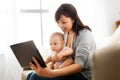 Asian mother with baby son and tablet pc at home Royalty Free Stock Photo