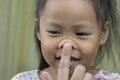 Asian mother and child girl playing pinch cheeks, touch nose funny face