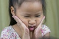 Asian mother and child girl playing pinch cheeks, touch nose funny face