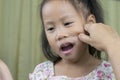 Asian mother and child girl playing pinch cheeks, touch nose funny face