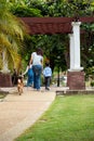 Asian mother child and girl walking together with Shiba inu dog in public park back view Royalty Free Stock Photo