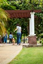 Asian mother child and girl walking together with Shiba inu dog in public park back view Royalty Free Stock Photo