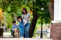 Asian mother child and girl walking together with Shiba inu dog in public park Royalty Free Stock Photo