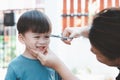 Asian mother cuts her son`s hair by herself at home. Happy haircut ideas for kids Royalty Free Stock Photo