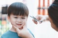 Asian mother cuts her son`s hair by herself at home. Happy haircut ideas for kids. Royalty Free Stock Photo