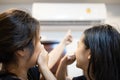 Asian mother and daughter are closing her nose, bad smell,musty smell of air conditioner has a problems,dust and dirt coming in