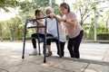 Asian mother and daughter help,care,support outdoor senior grandmother after cross the road,barrier from footpath,sidewalk is tall Royalty Free Stock Photo