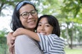 Asian mother and daughter hug each and smiling  other at the park, Happy family concept Royalty Free Stock Photo