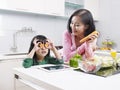 Asian mother and daughter in kitchen