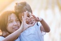 Asian mother and daughter making heart shape with hands together with love in the field Royalty Free Stock Photo