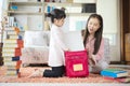 An Asian mother and daughter pack her backpacks to school preparing to go to school Royalty Free Stock Photo