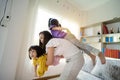 An Asian mother and daughter are playing happily in her home