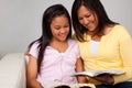 Asian mother and daughter reading and studying. Royalty Free Stock Photo
