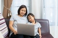Asian mother and daughter using laptop studying homework online lesson Royalty Free Stock Photo