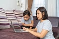 Asian mother and daughter using laptop studying homework online Royalty Free Stock Photo