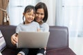 Asian mother and daughter using laptop studying homework online lesson Royalty Free Stock Photo