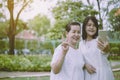 Asian mother and daughter woman selfie with mobile phone together at nature,Daughter take care and support,Enjoying time,Positive Royalty Free Stock Photo