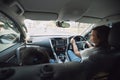 Asian mother driving a car with her daughter traveling to school together with happiness. Royalty Free Stock Photo