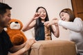 Asian mother, father, and pretty daughter playing wooden block tower together in playtime in living room. Happy and fun family Royalty Free Stock Photo