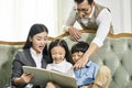 Asian mother and father and two children reading book together Royalty Free Stock Photo