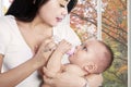 Asian mother feeding her baby girl Royalty Free Stock Photo