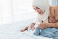 Asian mother feeding milk from bottle milk to her 2-month-old baby newborn girl Royalty Free Stock Photo