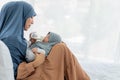 Asian mother feeding milk from bottle milk to her 2-month-old baby newborn girl, Royalty Free Stock Photo