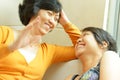 Asian mother happy talking with teen daughter