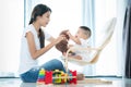 Asian mother and har baby play teddy bear togather Royalty Free Stock Photo